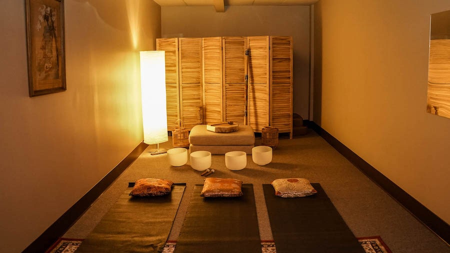 room with warm lamp light and yoga mats on the floor