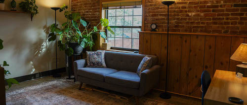 Montclair office with sofa and exposed brick wall