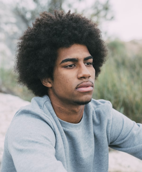 man sitting outdoors looking serious