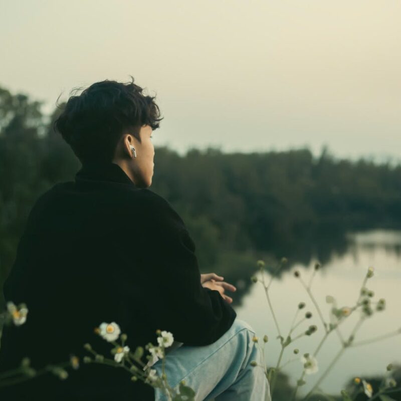 contemplative-young-man-by-riverside
