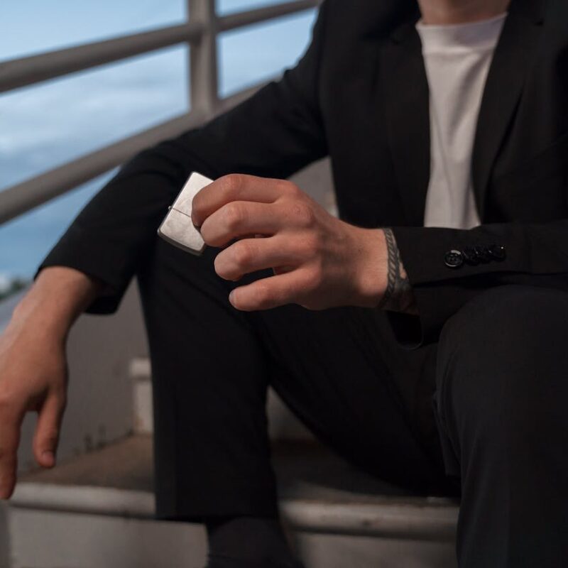 person-s-hand-holding-a-silver-zippo