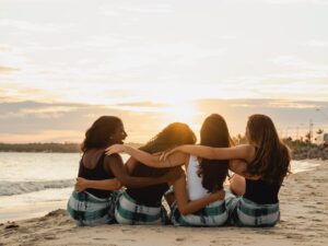 back-view-of-a-group-of-women-sitting-on-the-beach