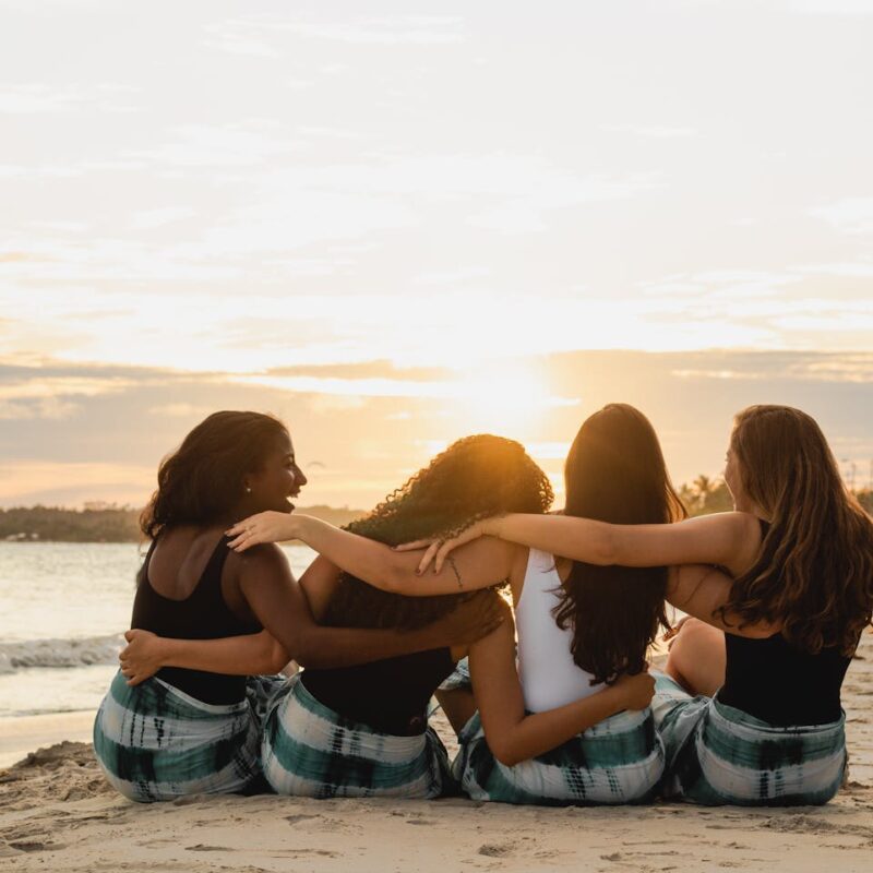 back-view-of-a-group-of-women-sitting-on-the-beach
