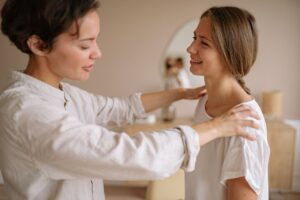 woman-in-white-dress-up-shirt-holding-the-shoulder-of-woman-in-white-t-shirt